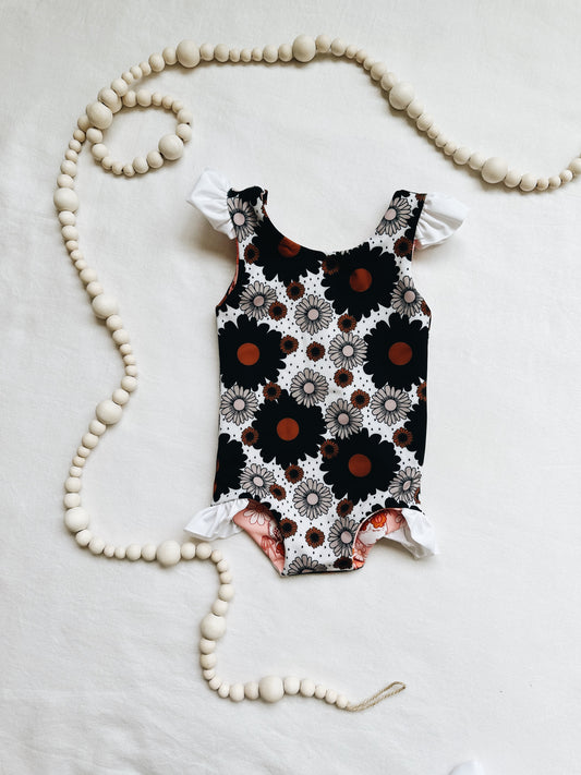 Black and white polka dot floral ruffle one piece reversible swim suit