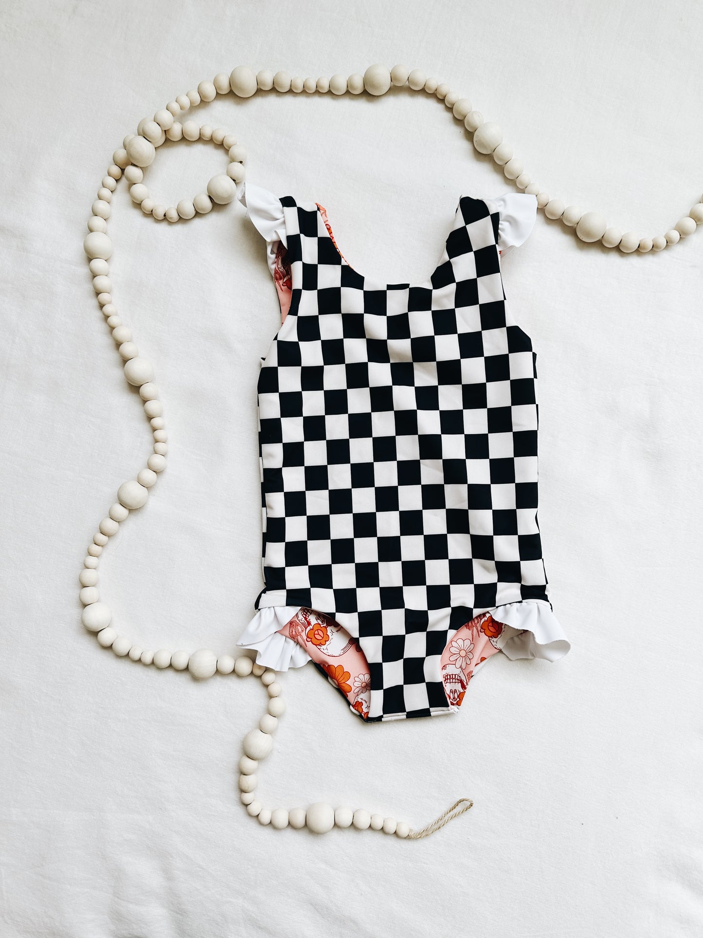 Black and white checker ruffle one piece reversible swim suit
